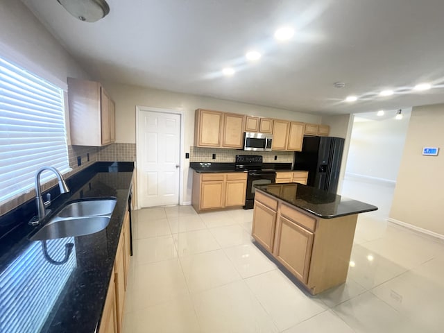 kitchen featuring sink, tasteful backsplash, black appliances, a kitchen island, and light brown cabinetry