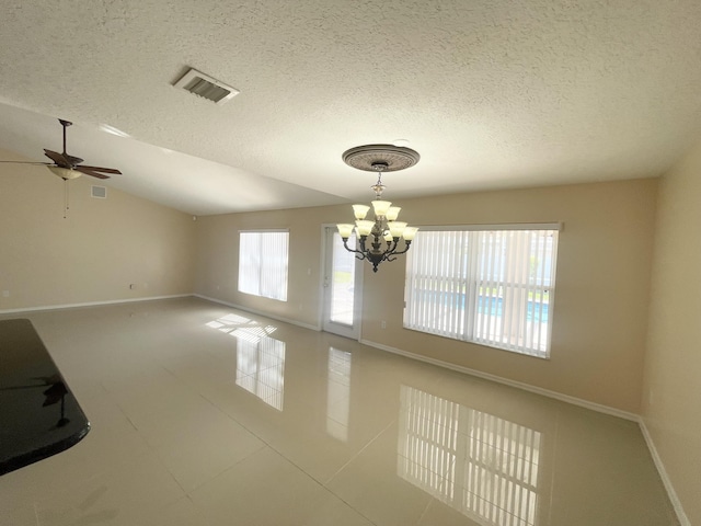 spare room with ceiling fan with notable chandelier, tile patterned floors, vaulted ceiling, and a textured ceiling