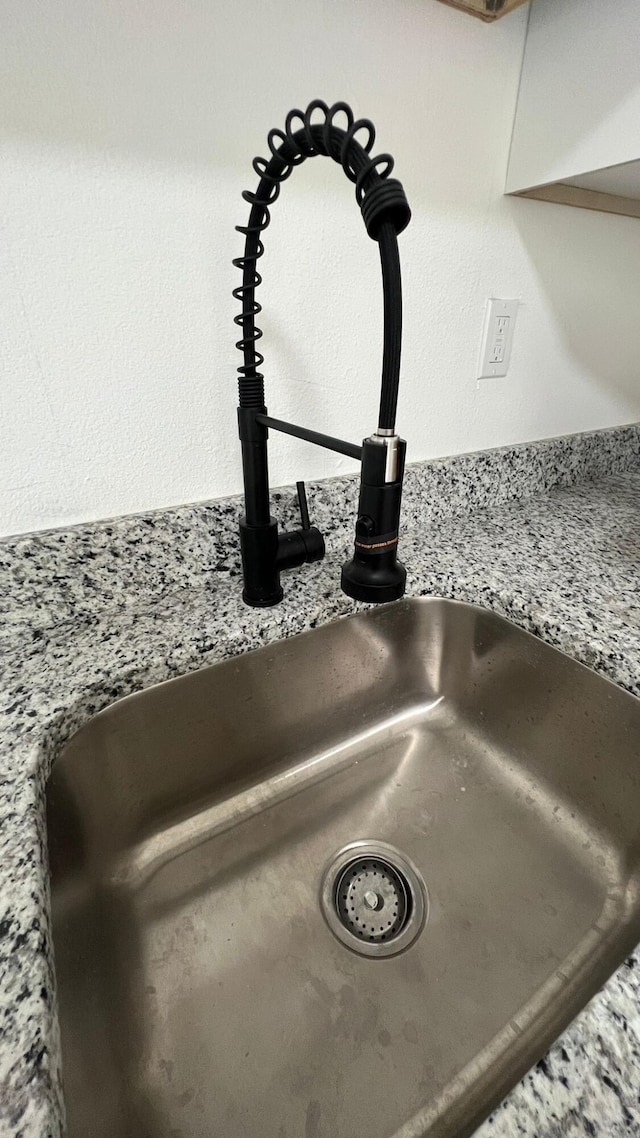 interior details with sink and stone countertops