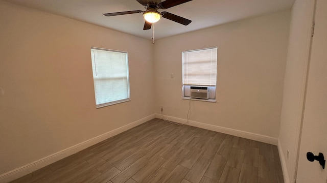 spare room with cooling unit, ceiling fan, and hardwood / wood-style floors