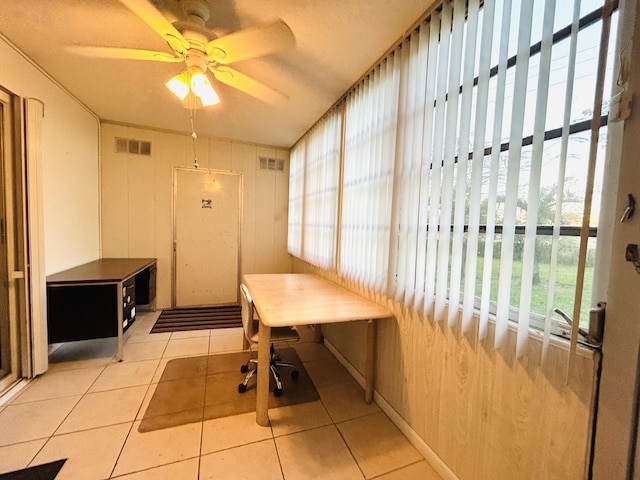 interior space with ceiling fan