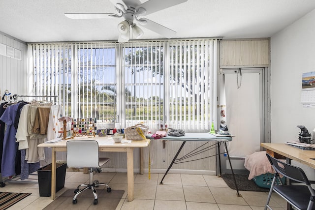 tiled home office featuring ceiling fan and a textured ceiling