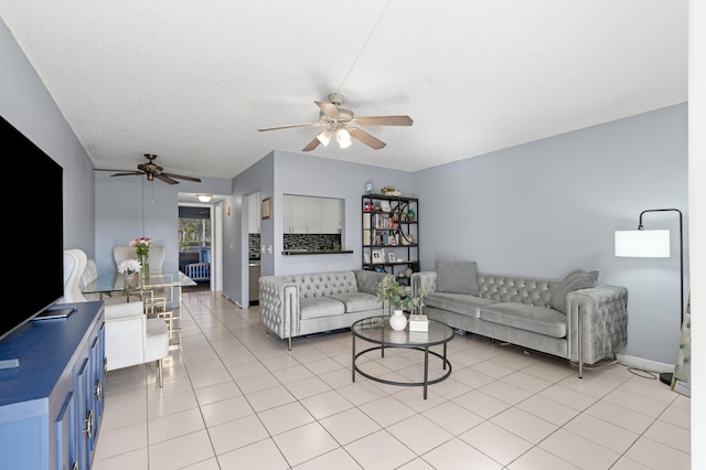 living room featuring light tile patterned floors and ceiling fan