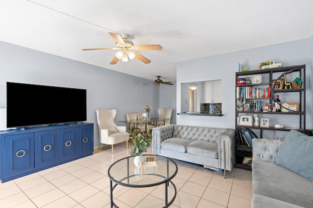 tiled living room featuring ceiling fan and a textured ceiling