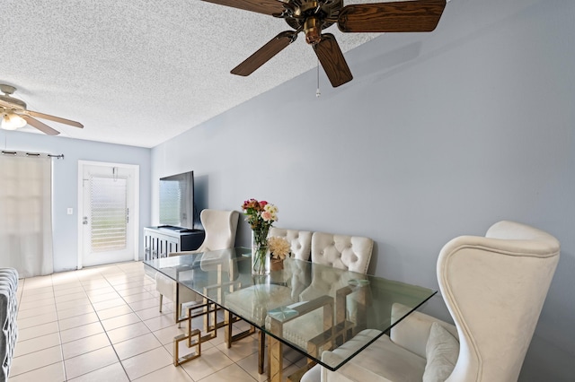 tiled dining area featuring ceiling fan and a textured ceiling