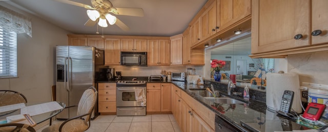 kitchen with dark stone countertops, sink, light brown cabinets, and black appliances