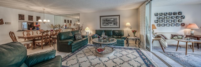 tiled living room featuring a textured ceiling and a notable chandelier