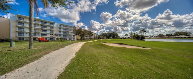 surrounding community featuring a water view and a yard