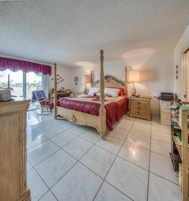 bedroom featuring light tile patterned floors, access to exterior, and a textured ceiling