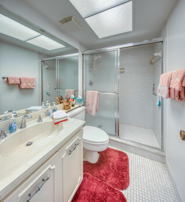 bathroom featuring vanity, an enclosed shower, tile patterned flooring, and toilet