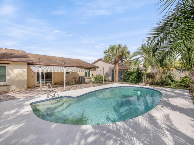 view of pool featuring cooling unit and a patio area