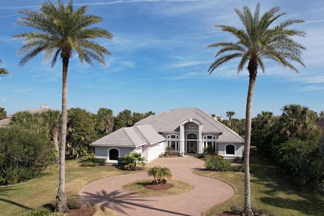 133 Island Estates Pkwy, Palm Coast, FL 32137 - view of front of property with a garage and a front lawn