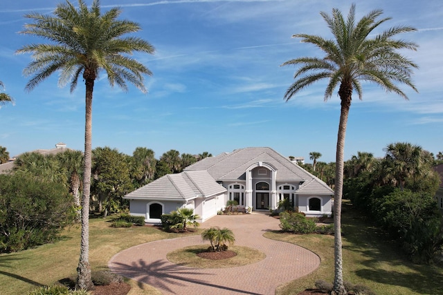 view of front of property with a garage and a front lawn