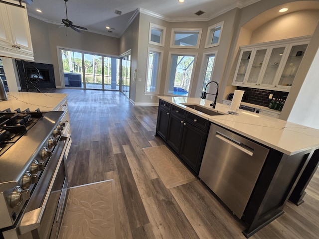 kitchen featuring light stone countertops, appliances with stainless steel finishes, sink, and white cabinets