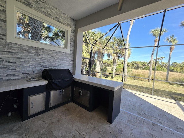 view of patio / terrace featuring an outdoor kitchen and sink