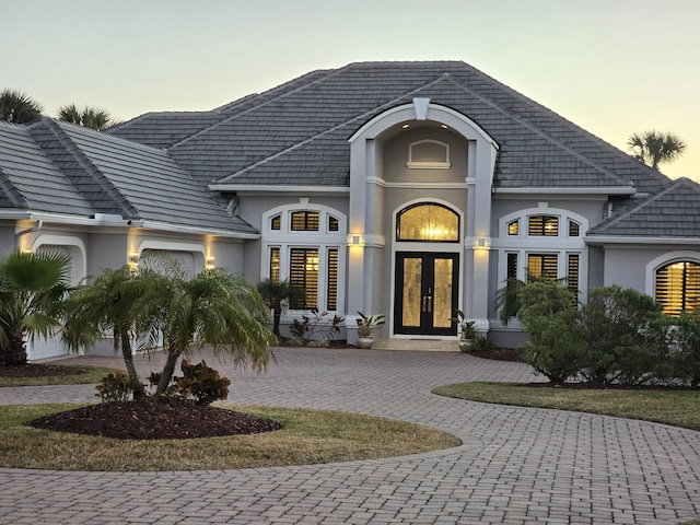 back house at dusk with french doors