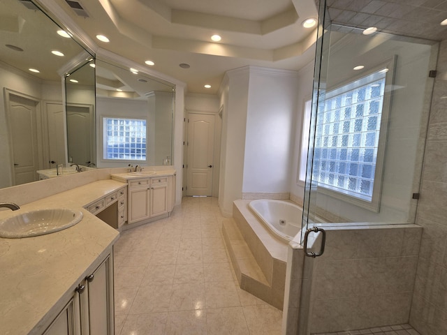 bathroom with tile patterned flooring, vanity, a tray ceiling, ornamental molding, and plus walk in shower