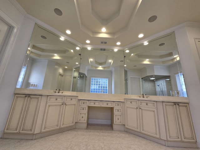 bathroom with a raised ceiling, vanity, ornamental molding, and an enclosed shower