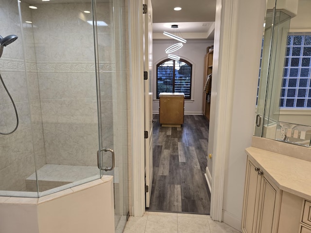 bathroom featuring vanity, crown molding, an enclosed shower, and tile patterned floors