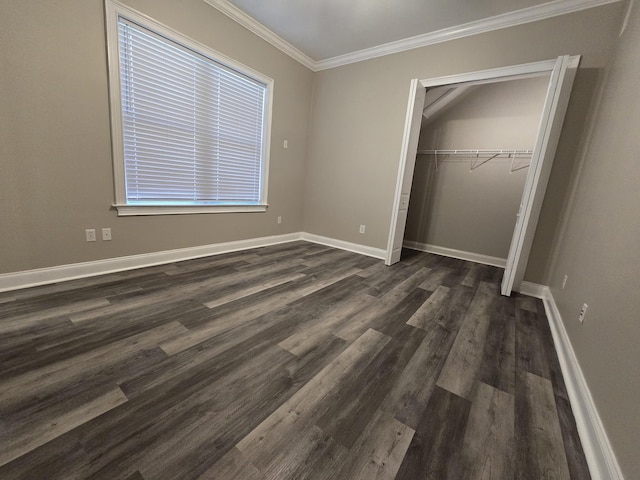 unfurnished bedroom featuring ornamental molding, dark hardwood / wood-style flooring, and a closet