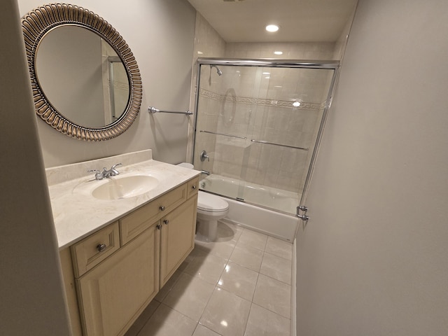 full bathroom featuring enclosed tub / shower combo, tile patterned floors, toilet, and vanity