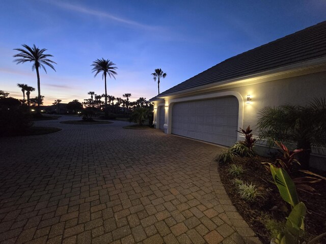 view of garage at dusk