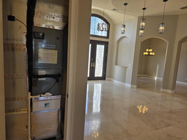 entryway featuring a towering ceiling and french doors