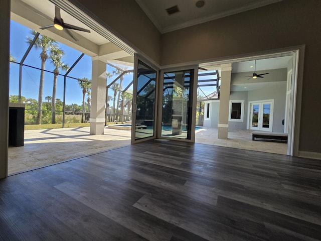 view of patio featuring ceiling fan and glass enclosure