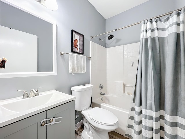 full bathroom with hardwood / wood-style flooring, shower / tub combo with curtain, vanity, and toilet