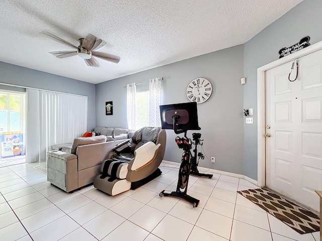 living room with light tile patterned floors, a textured ceiling, and ceiling fan