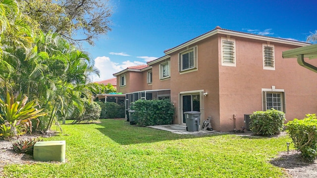 back of property featuring a lawn