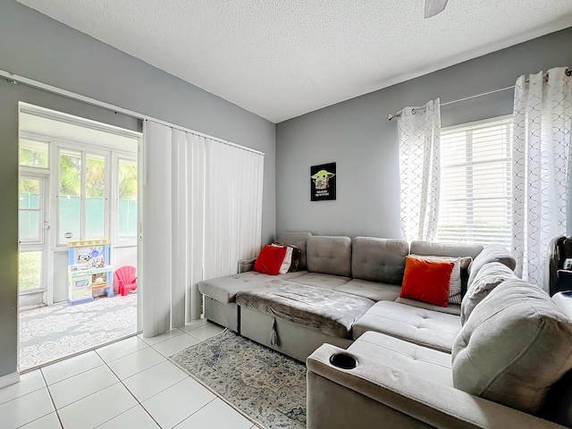 tiled living room with a wealth of natural light and a textured ceiling