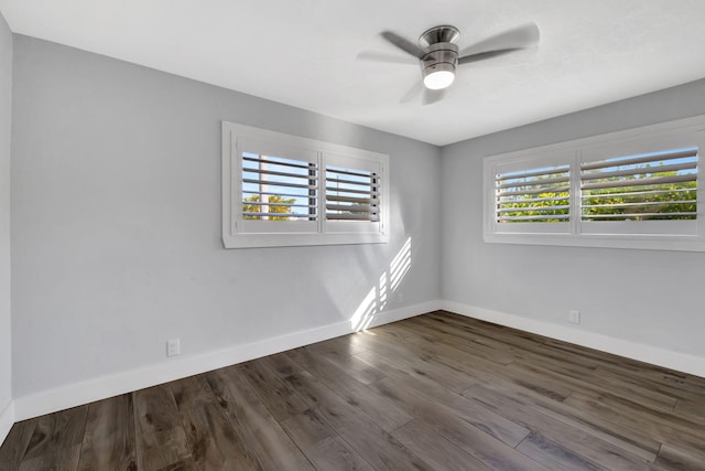 empty room featuring ceiling fan and dark hardwood / wood-style floors