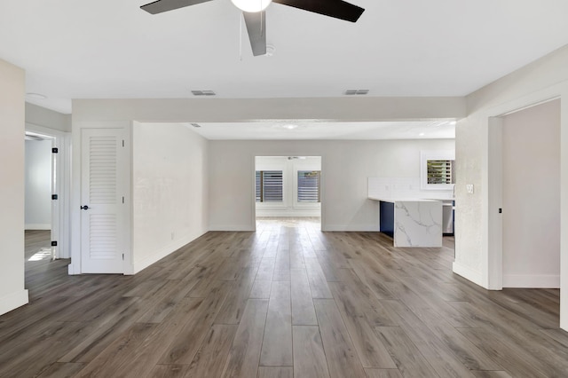 unfurnished living room featuring hardwood / wood-style floors and ceiling fan