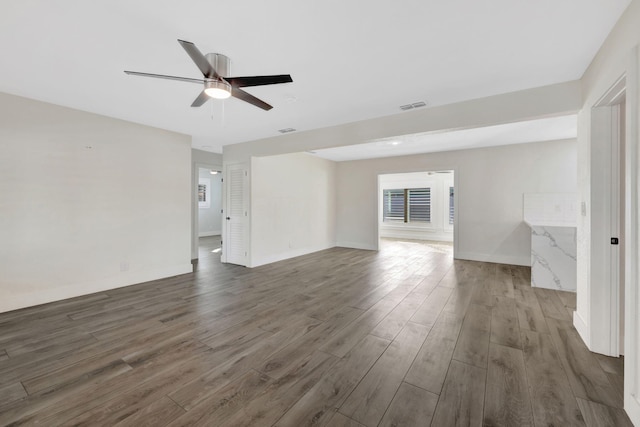 unfurnished living room with ceiling fan and dark hardwood / wood-style floors