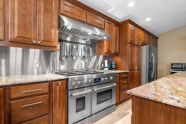 kitchen with light stone counters, vaulted ceiling, light tile patterned floors, stainless steel appliances, and range hood