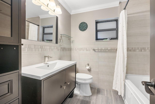 full bathroom with toilet, vanity, tile walls, ornamental molding, and shower / bath combo with shower curtain