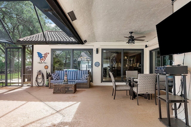 view of patio / terrace with glass enclosure, outdoor dining area, an outdoor hangout area, and a ceiling fan