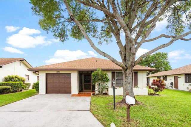 ranch-style house featuring a garage and a front yard