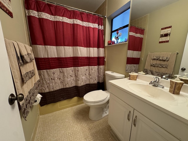 bathroom with vanity, walk in shower, tile patterned floors, and toilet