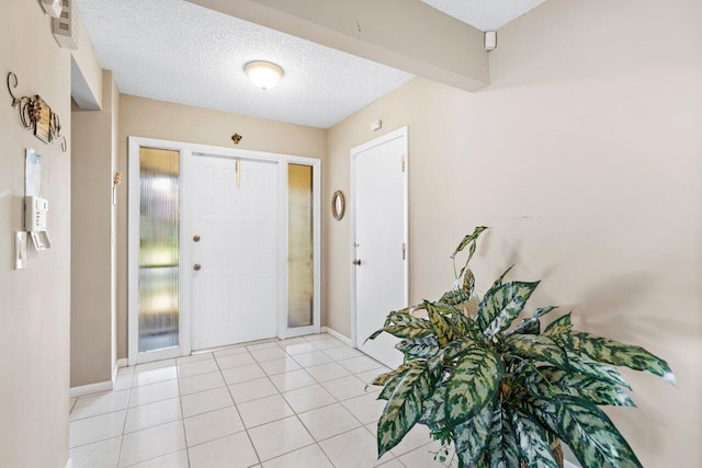 tiled foyer entrance with a textured ceiling