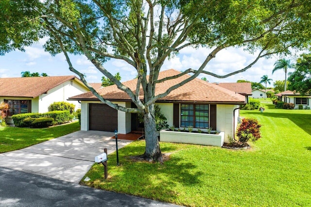 ranch-style house with a garage and a front yard