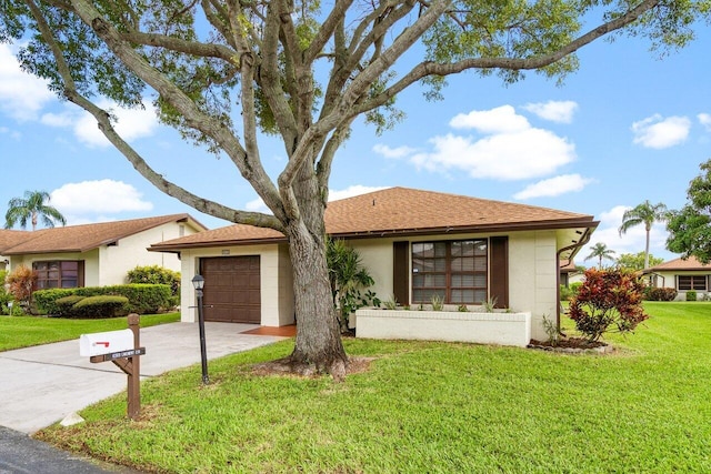 view of front of property with a garage and a front lawn