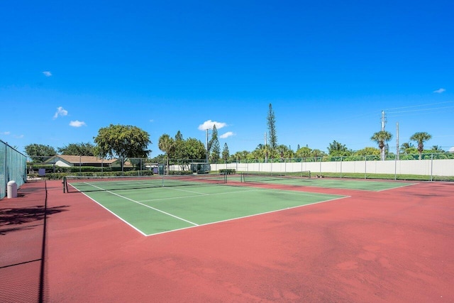 view of tennis court with basketball hoop