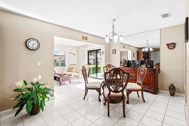 tiled dining area with a textured ceiling and a chandelier