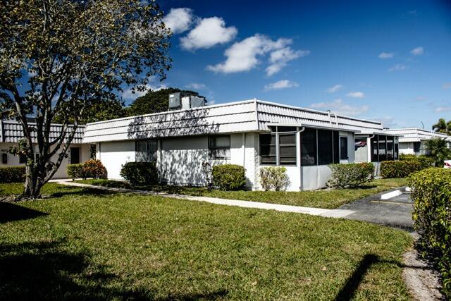 view of side of home with a lawn