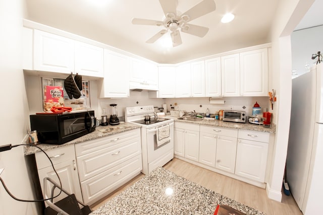 kitchen featuring sink, white cabinetry, ceiling fan, white appliances, and light stone countertops