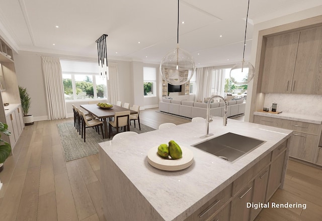 kitchen with crown molding, a large island, decorative light fixtures, and light wood-type flooring