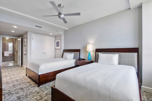 bedroom featuring ensuite bathroom, light colored carpet, ceiling fan, and a closet