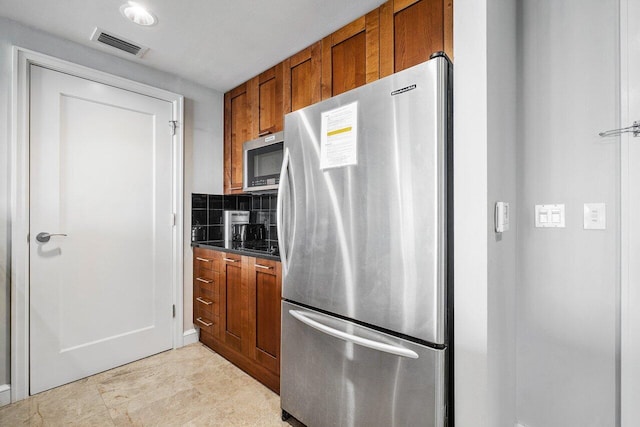 kitchen with backsplash and appliances with stainless steel finishes